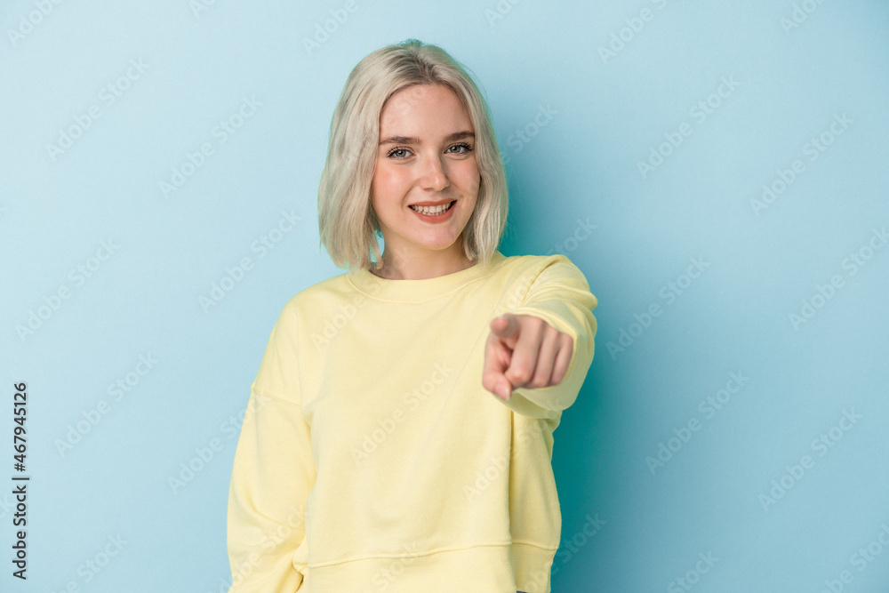 Young caucasian woman isolated on blue background cheerful smiles pointing to front. Young caucasian woman isolated on blue background cheerful smiles pointing to front.