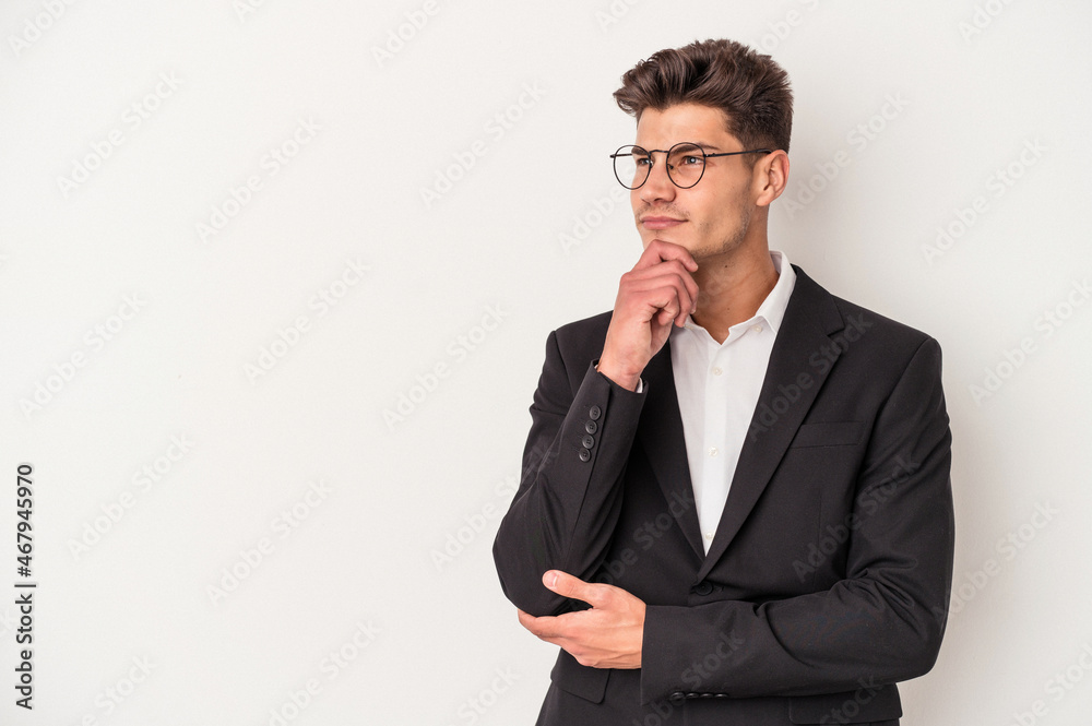 Young business caucasian man isolated on white background looking sideways with doubtful and skeptical expression. Young business caucasian man isolated on white background looking sideways with doubtful and skeptical expression.