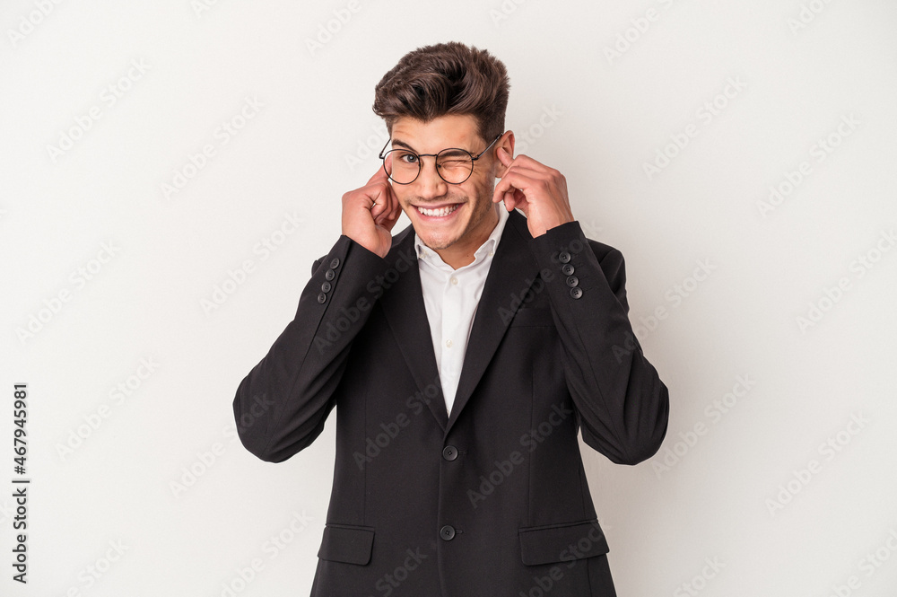 Young business caucasian man isolated on white background covering ears with hands. Young business caucasian man isolated on white background covering ears with hands.