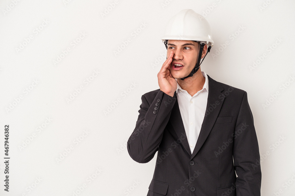 Young architect caucasian man isolated on white background is saying a secret hot braking news and looking aside Young architect caucasian man isolated on white background is saying a secret hot braking news and looking aside
