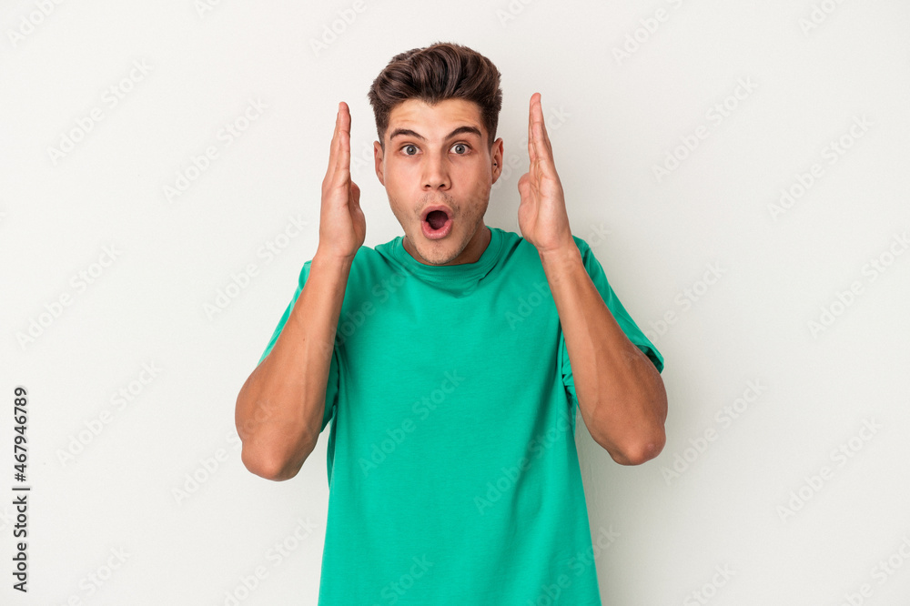 Young caucasian man isolated on white background surprised and shocked. Young caucasian man isolated on white background surprised and shocked.