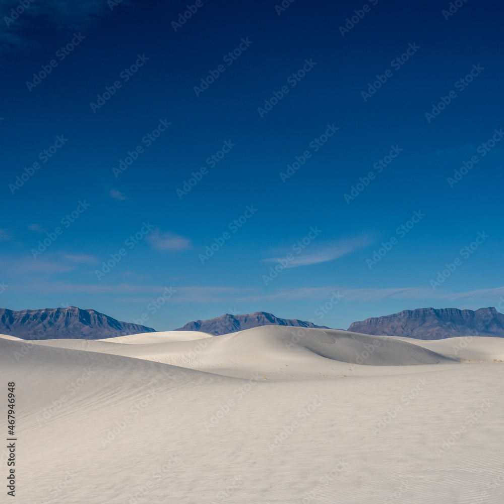Smooth Dunes and Jagged Mountains Below Deep Blue Sky Smooth Dunes and Jagged Mountains Below Deep Blue Sky