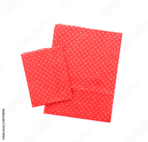 Red reusable beeswax food wraps on white background, top view