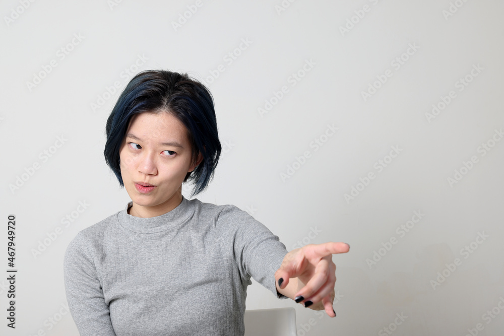 Young attractive Asian chinese malay woman pose face body expression mode emotion on white background angry annoyed point finger Young attractive Asian chinese malay woman pose face body expression mode emotion on white background angry annoyed point finger