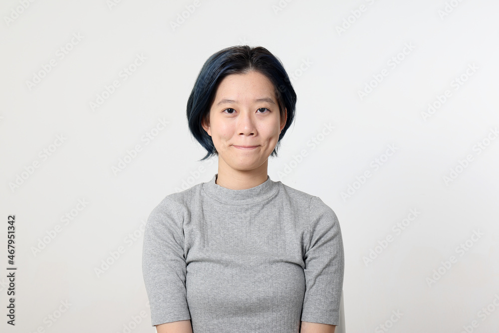 Young attractive Asian chinese malay woman pose face body expression mode emotion on white background smile lips tucked in Young attractive Asian chinese malay woman pose face body expression mode emotion on white background smile lips tucked in