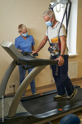 Mature patient doing exercises during rehabilitation in medical center