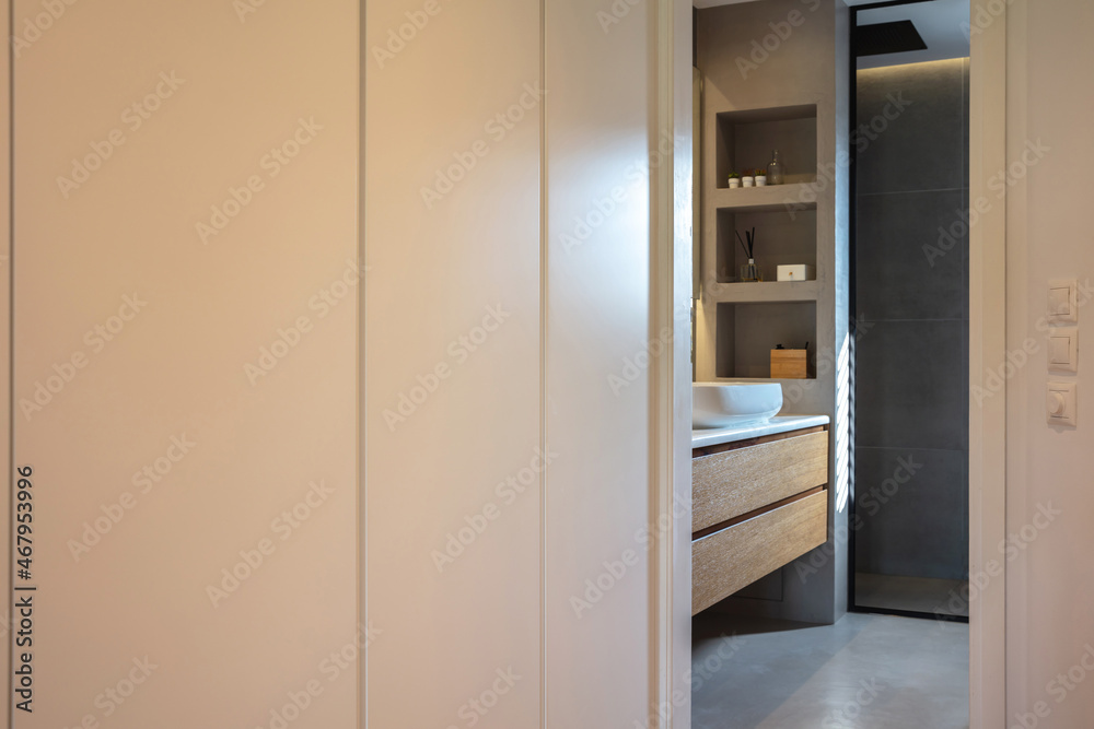 Bedroom wardrobe and bathroom, modern interior design. White clothing closet, and minimal style bath