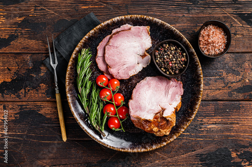 Fotografija Smoked pork meat - gammon with herbs on rustic plate