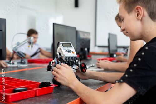 Wallpaper Mural Concentrated teen child programming robot at class, stem education concept Torontodigital.ca