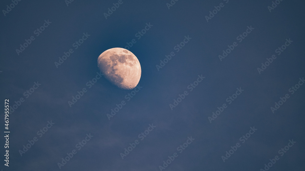 Full Moon In Isolation Against blue Sky. Telescopic view of a full moon Full Moon In Isolation Against blue Sky. Telescopic view of a full moon
