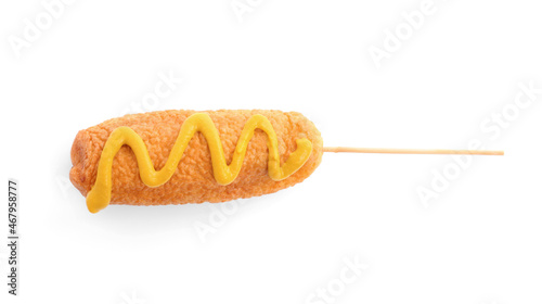 Delicious deep fried corn dog with mustard isolated on white, top view