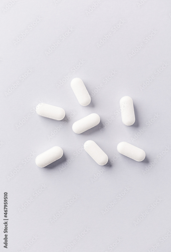 Potassium tablets. A dietary supplement on bright paper background. Top view. Close up. Copy space. Potassium tablets. A dietary supplement on bright paper background. Top view. Close up. Copy space.