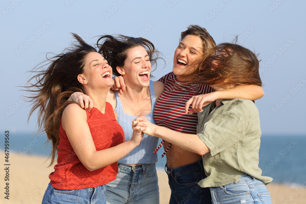 Excited friends jumping and celebrating on the beach Excited friends jumping and celebrating on the beach