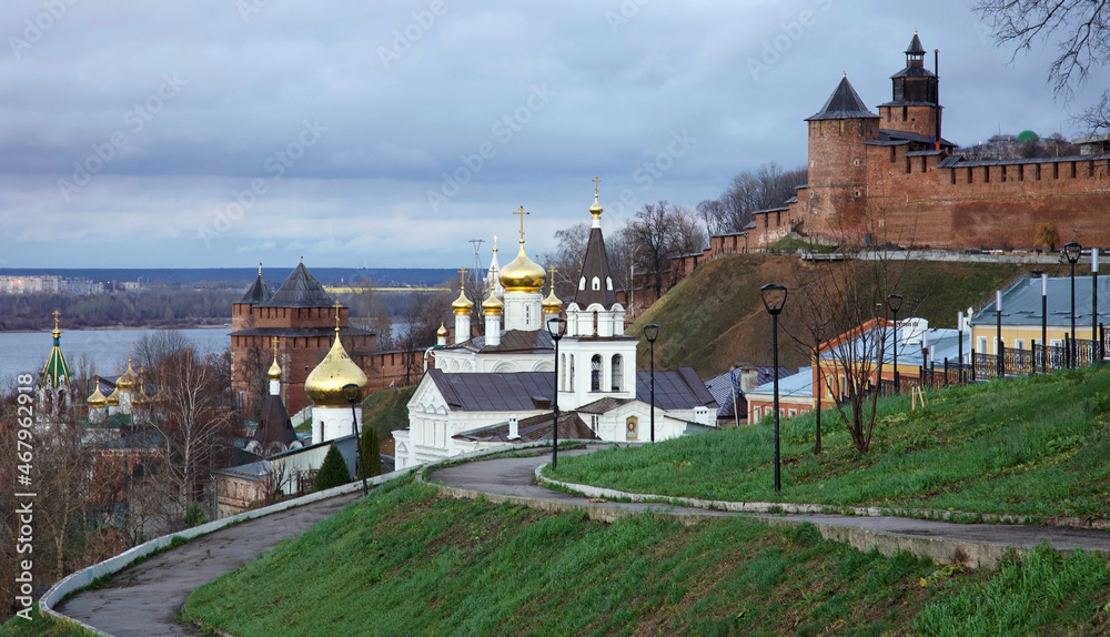 Orthodox ancient temple against the background of the Kremlin and the Volga river in Nizhny Novgorod