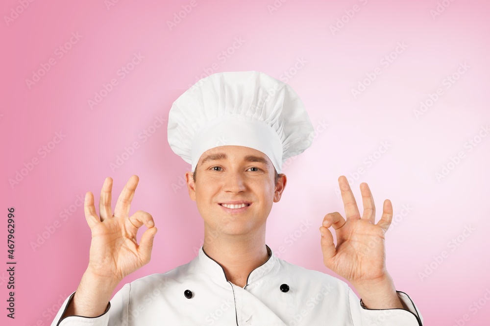 Cute young man cook posing in white uniform Cute young man cook posing in white uniform