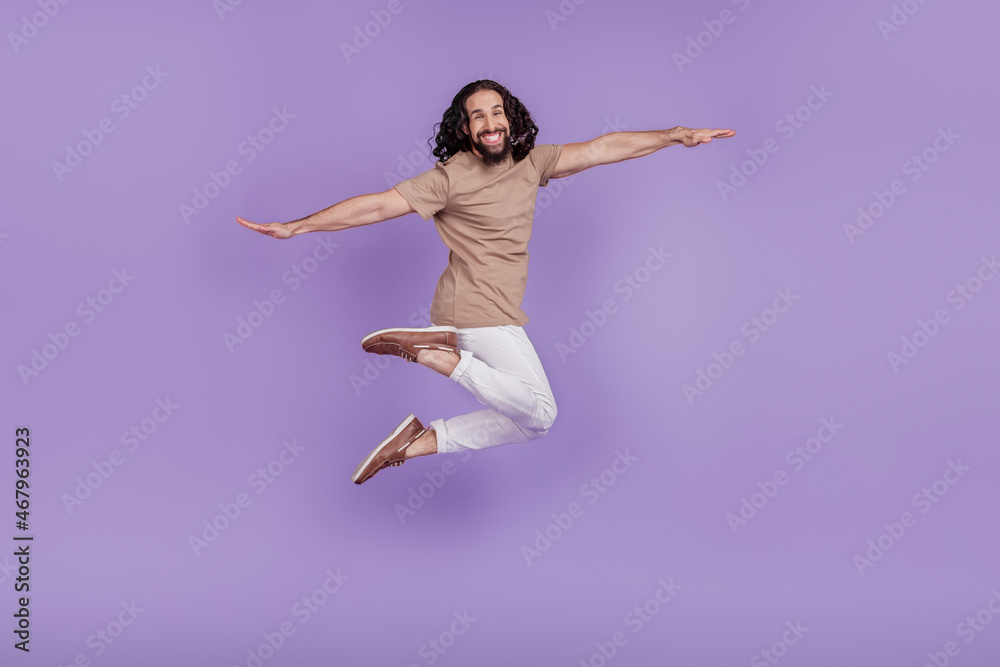 Full length profile side photo of young man hands wings fly carefree jumper isolated on purple color background