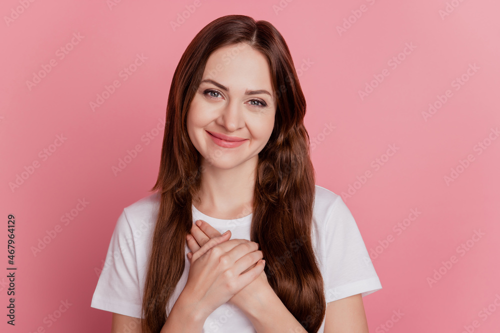Portrait of grateful sincere girl palms heart chest look camera on pink background Portrait of grateful sincere girl palms heart chest look camera on pink background