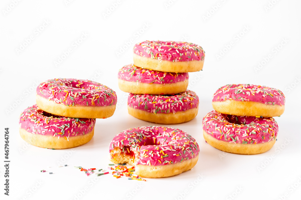 Close up of pink frosted donuts with colorful sprinkles