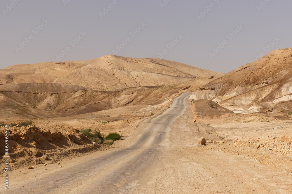 Road through hills and cliffs in the Judean Desert in Israel