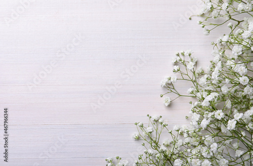 фотографія Beautiful gypsophila flowers on white wooden background, flat lay