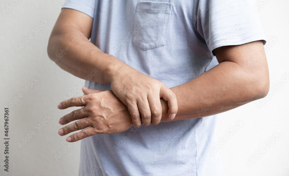 Man hand massage physiotherapy wrist is sore and numb, exhausted, tingling. Guillain-Barre Syndrome, a side effect of the Covid vaccination Man hand massage physiotherapy wrist is sore and numb, exhausted, tingling. Guillain-Barre Syndrome, a side effect of the Covid vaccination