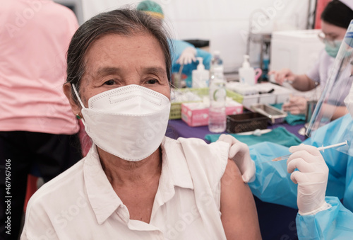 Asia senior woman has gone to vaccinate coronavirus covid19 with medical staff in a field hospitel. a place set up by the government photo