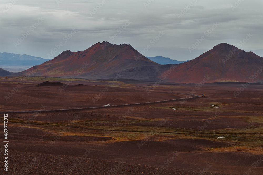 Highway crossing the desert with mountains in the background