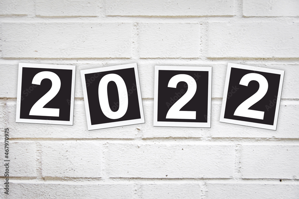 2022 written in instant photo frames on a brick wall 2022 written in instant photo frames on a brick wall
