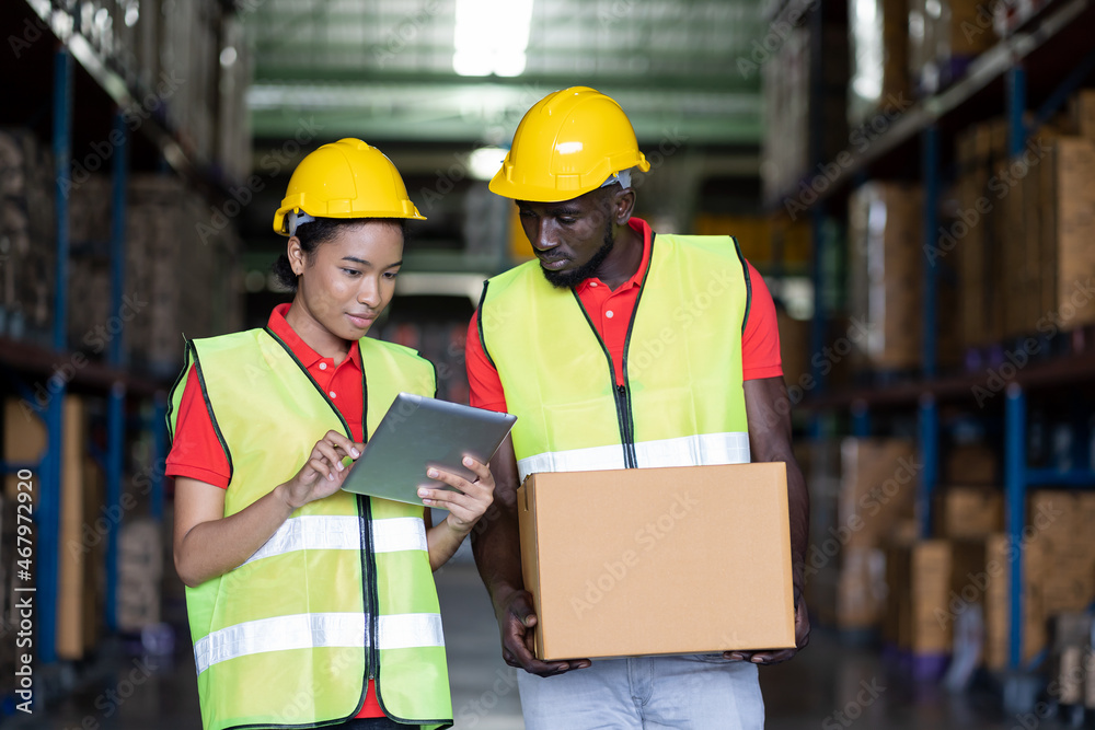 Group of African American worker working and moving or transfer products or parcel goods to shelf pallet in storage warehouse. teamwork concept Group of African American worker working and moving or transfer products or parcel goods to shelf pallet in storage warehouse. teamwork concept