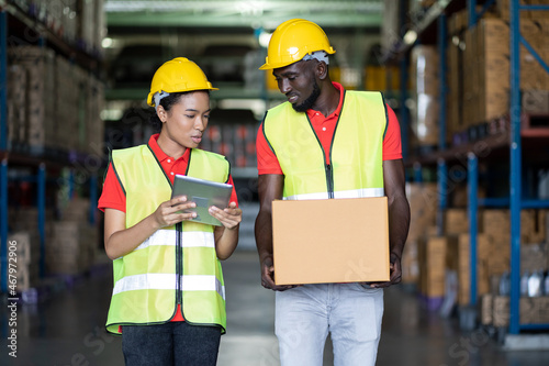 Group of African American worker working and moving or transfer products or parcel goods to shelf pallet in storage warehouse. teamwork concept