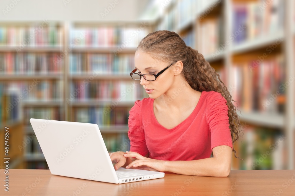 Young girl college student using laptop computer writing Young girl college student using laptop computer writing