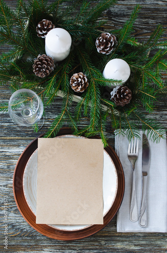 Christmas table setting with candles and fir branches