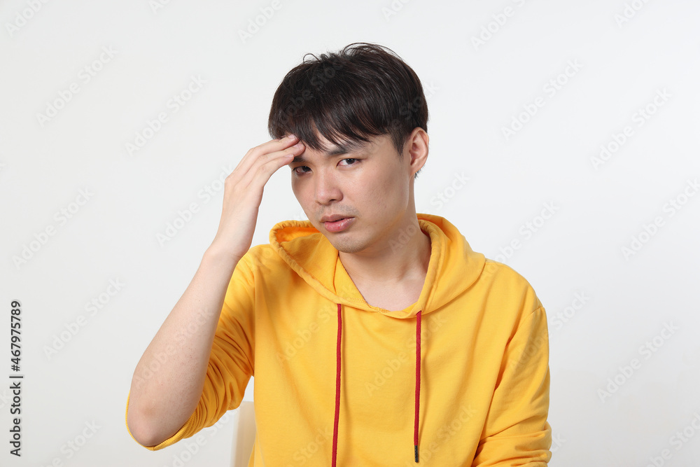 Young good looking Asian chinese malay man pose face body expression mode emotion on white background think worry hand on forehead Young good looking Asian chinese malay man pose face body expression mode emotion on white background think worry hand on forehead