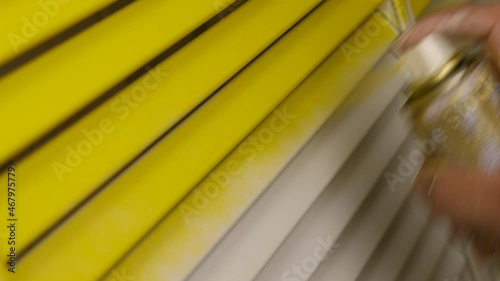 painting in yellow from a spray paint can. Yellow color matte paint 