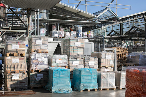 Modern warehouse of the retail hypermarket in the open air - the racks are full of goods in transport packaging