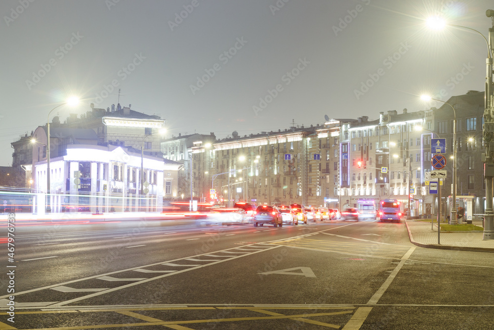 Fototapeta premium Moscow, Russia, Nov 2,2021: Night view of Yakimanka street near crossing with Bolshaya Polyanka street. Car traces. Long exposure