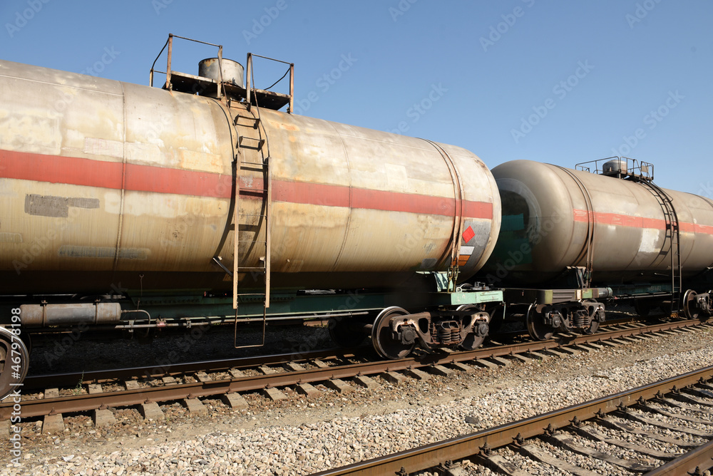 Freight cars and tanks with liquid on the railway on the background of the railway at the station Freight cars and tanks with liquid on the railway on the background of the railway at the station