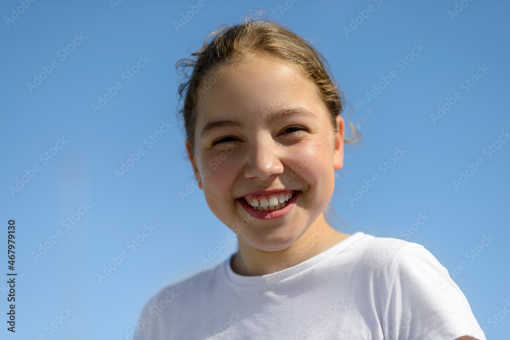 Happy teenage girl laughing sincerely on a warm sunny summer day. Happy teenage girl laughing sincerely on a warm sunny summer day.