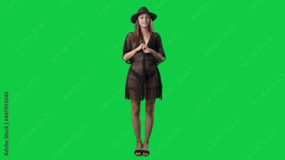 Woman in beach tunic and bikini argue at camera explaining and pointing finger. Full body isolated on green screen background Woman in beach tunic and bikini argue at camera explaining and pointing finger. Full body isolated on green screen background
