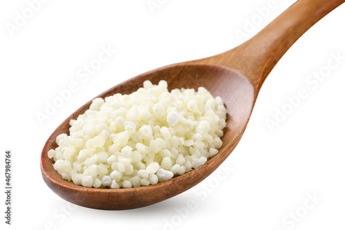 Sago in a wooden spoon on a white background. Isolated