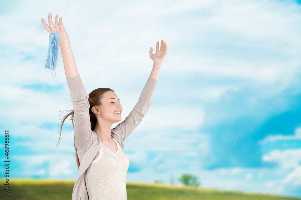 Woman with raising hands on the nature background Woman with raising hands on the nature background