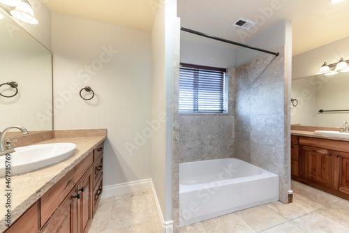 Master bathroom with bathtub in the middle of two vanities