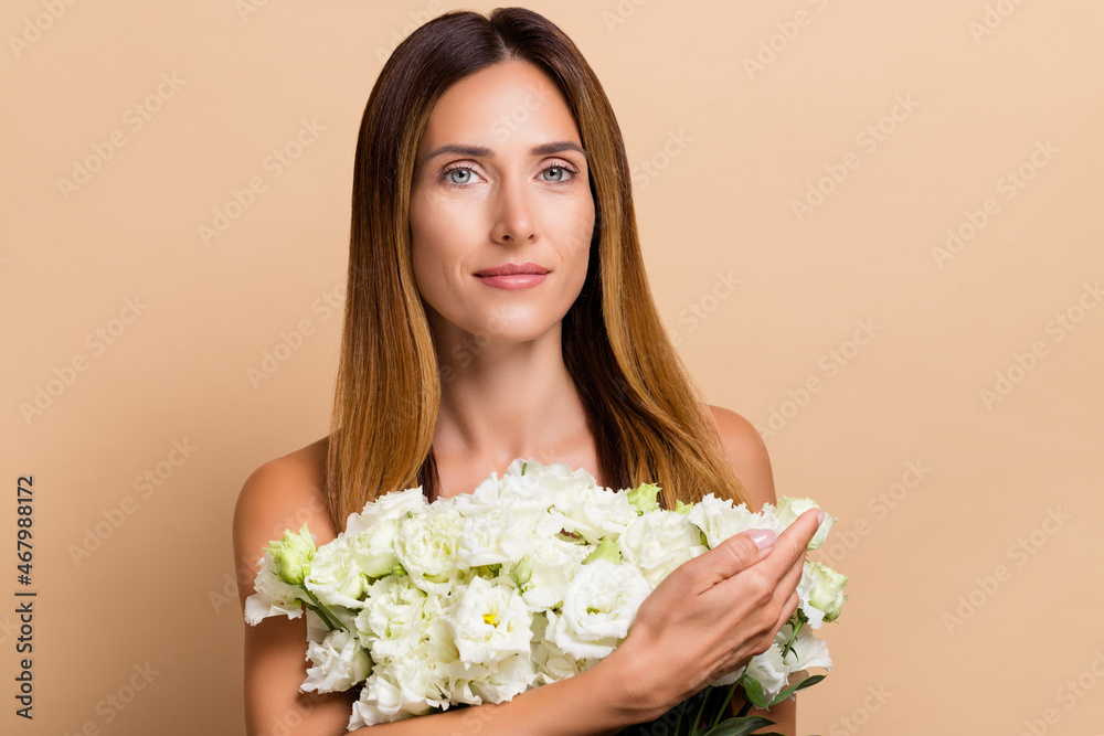 Portrait of attractive pure woman holding fresh floral romantic bunch roses isolated over beige pastel color background Portrait of attractive pure woman holding fresh floral romantic bunch roses isolated over beige pastel color background