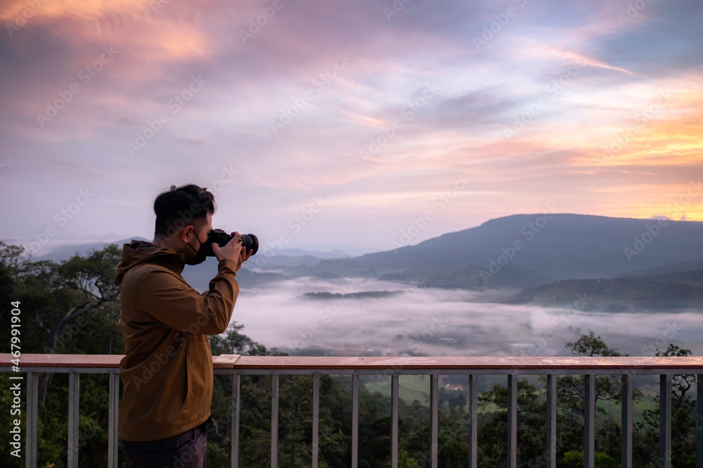Asian tourists take photos of mountains and sea of ​​clouds after a long lockdown of the country.