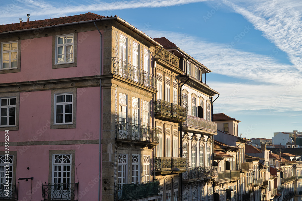 Colorful facades of old houses in Porto, Portugal. At sunrise.