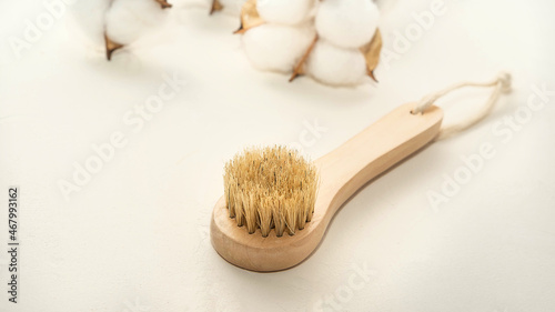 a small wooden eco-brush for facial massage with natural bristles