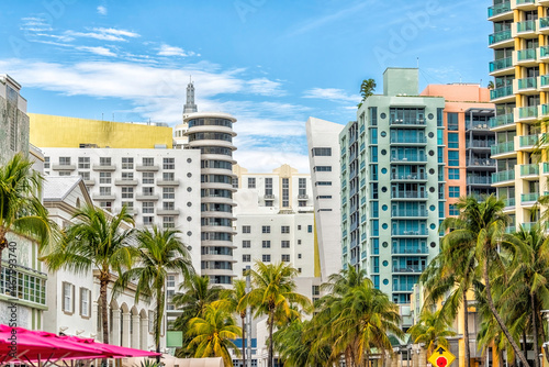 Miami South Beach Ocean Drive road street with famous retro art deco hotel colorful buildings cityscape with palm trees and blue sky on sunny day © Kristina Blokhin