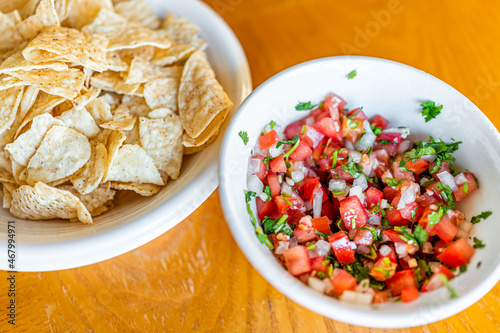 Photography Closeup of chunky red salsa of red tomatoes, sweet onion and cilantro with deep