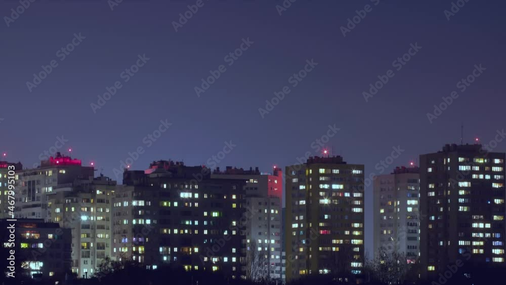 Time lapse from evening to night residential buildings windows lights at night, building facade. Lights in building windows turning on and off. Residential area, twinkling lights Time lapse from evening to night residential buildings windows lights at night, building facade. Lights in building windows turning on and off. Residential area, twinkling lights