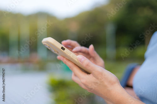 Woman use mobile phone at outdoor © leungchopan